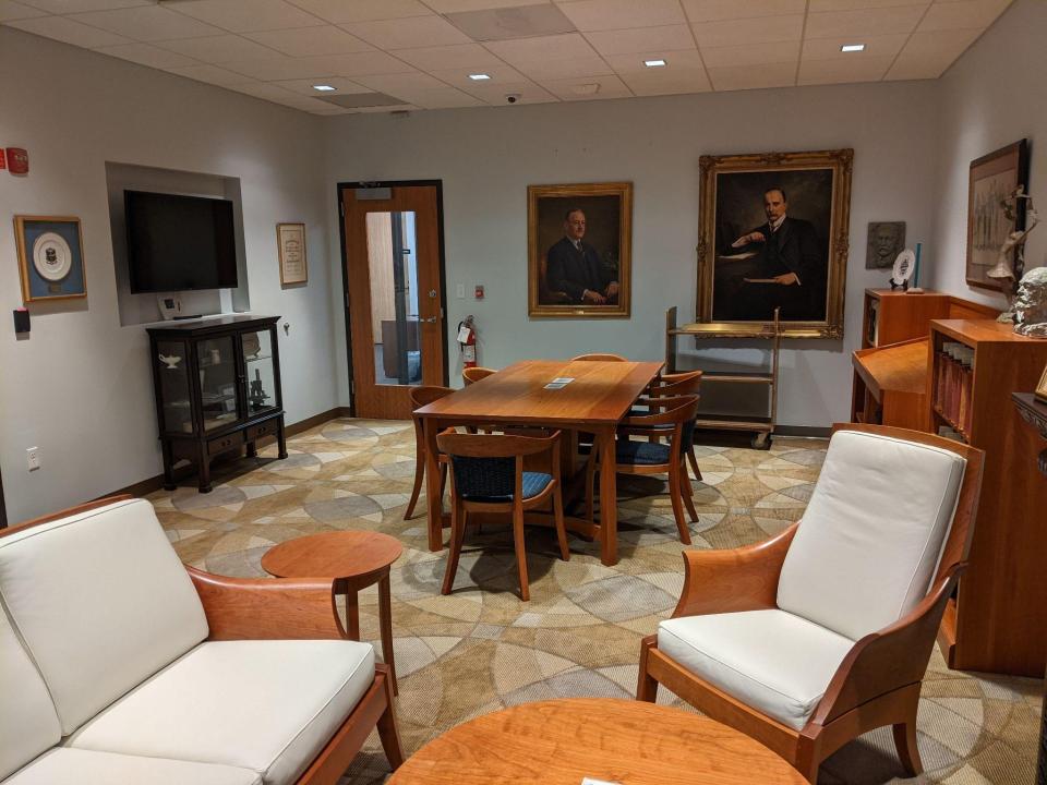 Rare Book Room in the TMC Library, Jesse Jone Building. Images shows a seating area, reading room table, shelves, books, and portraits of Drs. Bertner and Osler.
