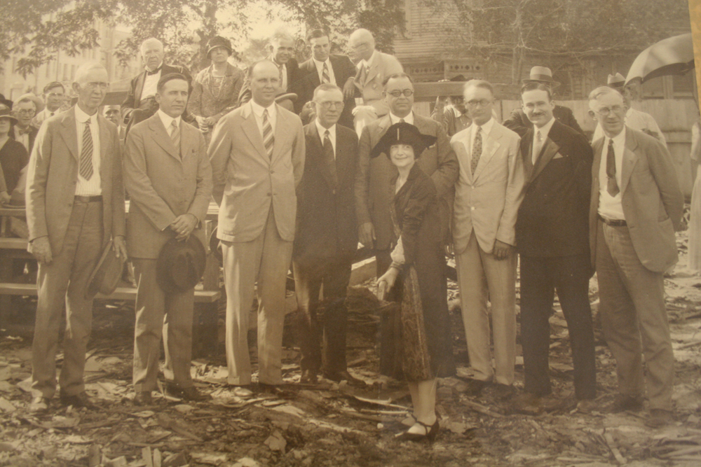 Groundbreaking for the Medical Arts Building at Caroline and Walker in downtown Houston, TX. Caption reads: "Mrs. T. A. Dickson (center), President of the Ladies’ Auxiliary of the Harris County Medical Society, turned the first spade of earth for the site of the new $1,750,000 Medical Arts Building, Caroline Street and Walker Avenue, From left to right are: DR. John T. Moore, Vice President; Dr. E. H. Lancaster, Director; Dr. Ralph Cooley, Director; Dr. John Foster, Director; Dr. W. G. Priester, Vice President; Don Hall, Contractor; Dr. Munford W. Hoover, Director, and Dr. A. H. Flickwir, Secretary-Treasurer." [McGovern Historical Center, Framed Oversize]