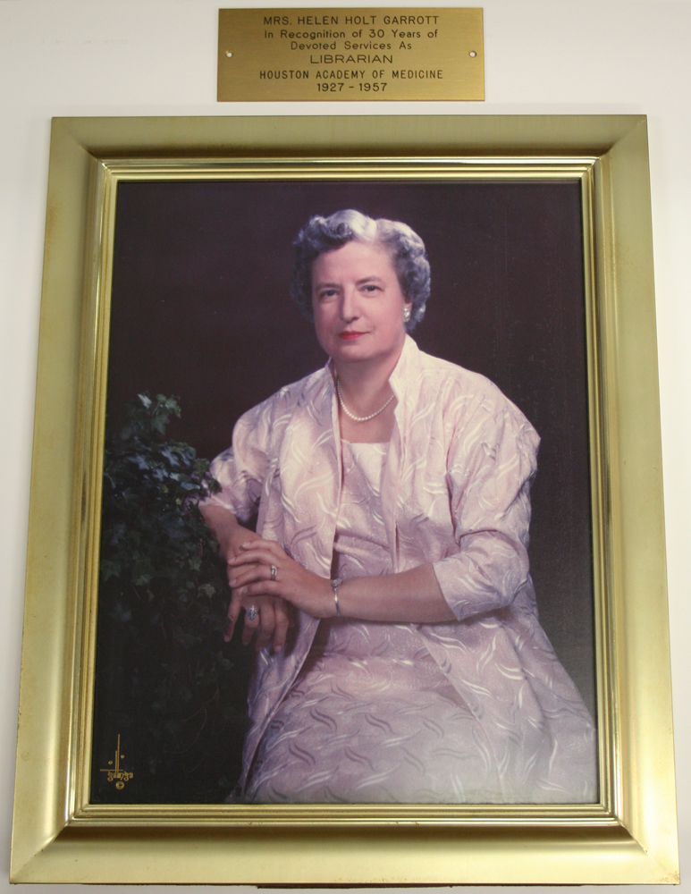 Framed photograph of Helen Holt Garrott with plaque that reads, "Mrs. Helen Holt Garrott, in Recognition of 30 Years of Devoted Services As Librarian, Houston Academy of Medicine, 1927 - 1957" [P-3355, Oversize, McGovern Historical Center]