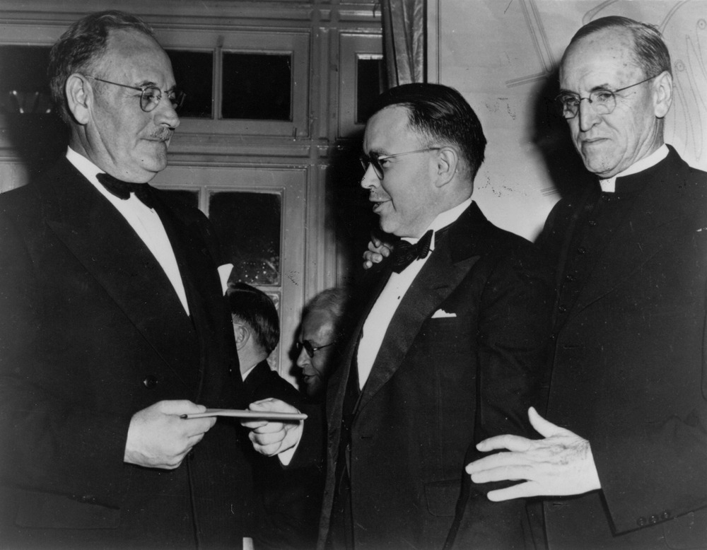 Dr. E. W. Bertner (left), President of the Texas Medical Center, receives a certificate from Leland Anderson (center) and Bishop Clinton S. Quinn at the Texas Medical Center Dedication Dinner, February 28, 1946. [IC 098 TMC Library Historical Photograph Collection, McGovern Historical Center, Texas Medical Center Library]