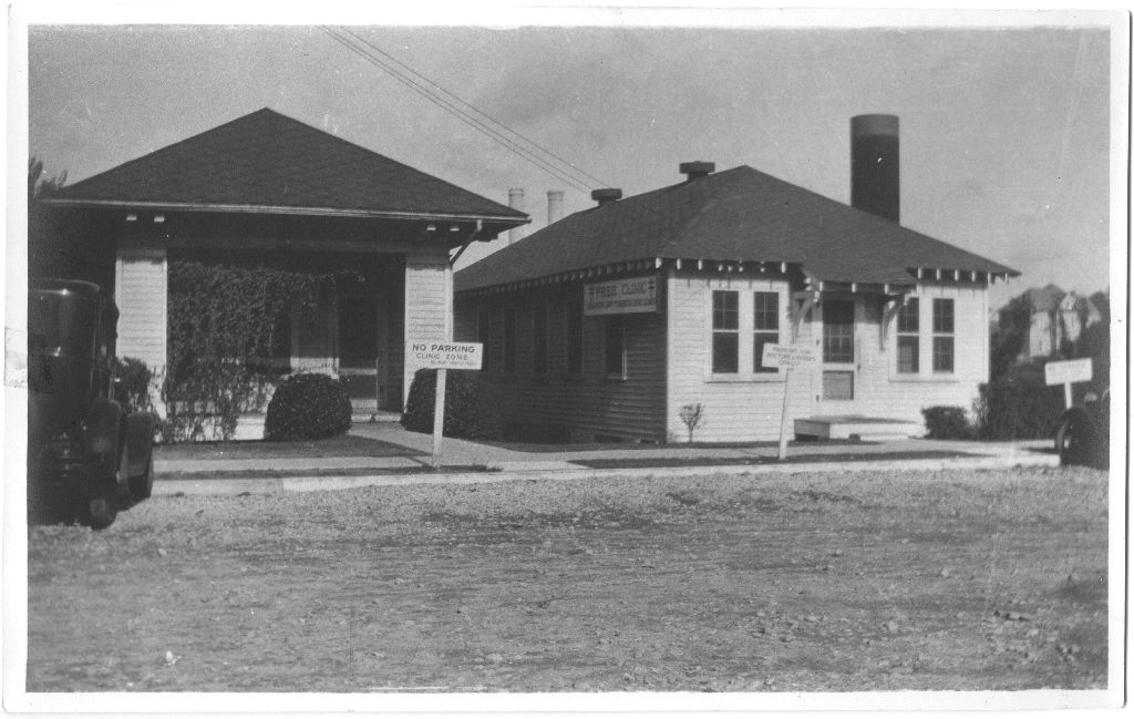 Expanded Houston Anti-Tuberculosis League and Clinic on Bagby St., c. 1930s. Description reads, "The clinic was hedged in by heavy traffic of the adjoining courthouse, hence the signs 'No Parking - Clinic Zone.' The 6-foot high board fence the Sheriff built alongside the clinic to keep the TB germs from hopping into the Courthouse Square unfortunately does not show in this picture." [San Jacinto Lung Association records, Box 5, P-775, McGovern Historical Center, Texas Medical Center Library.]