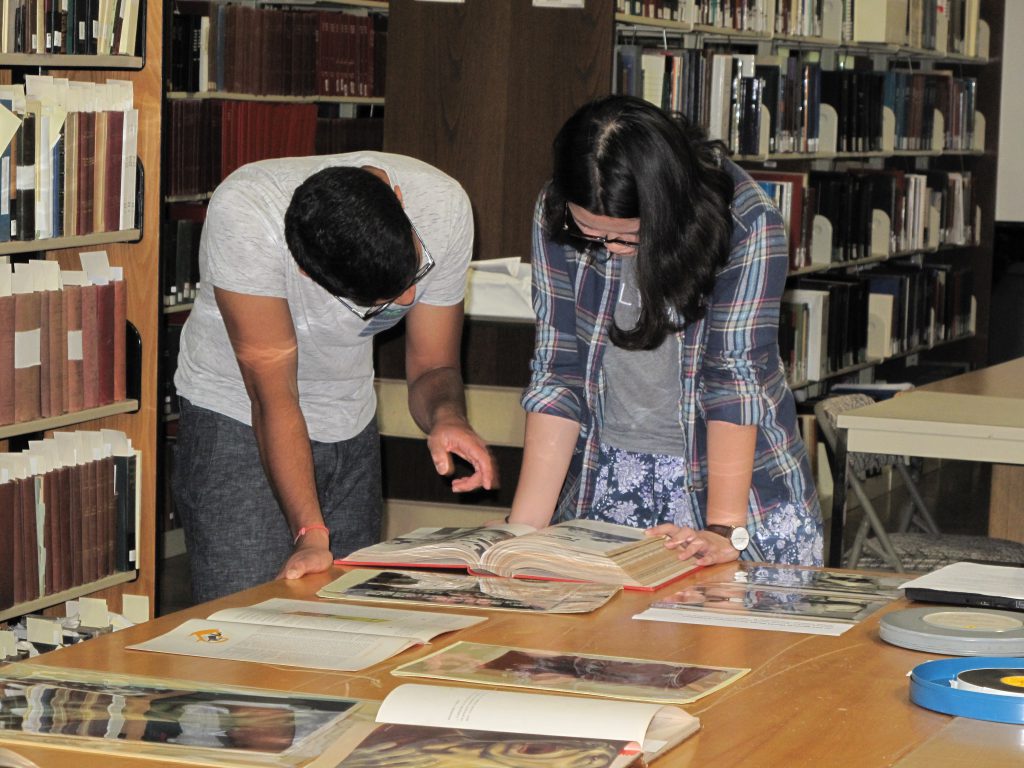 Students from Rice University examine articles and photographs from the Medical World News Photograph Collection (IC 077) at the McGovern Historical Center.