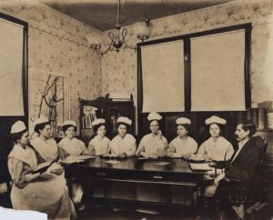 Bible Study, D. R. Pevoto and first class of nursing students of the Baptist Sanitarium and Hospital Training School for Nurses (later Memorial Hospital), circa 1909. Graduates from the school received a Registered Nurse certificate as well as a Sunday School Teacher certificate. [Memorial Hospital System records, McGovern Historical Center, Texas Medical Center Library, IC 022, IC022-1909-70sPhotos-01-001]