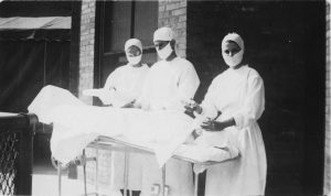 Nurses, surgeon, and patient on roof top of Memorial Hospital. It looks like a surgical exercise. [Memorial Hospital Photograph Collection, Series I: Lela Smith Hickey, McGovern Historical Center, Texas Medical Center Library, IC 103, IC103-P176-006]