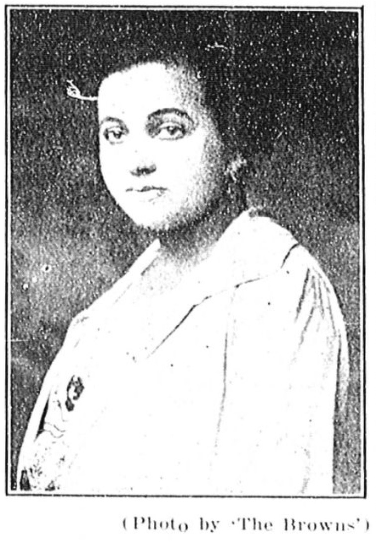 Carrie Jane Sutton, M.D. in white coat. From The Richmond Planet, 1921.