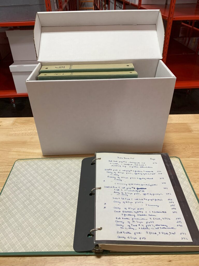 [An archival box containing three of Dr. Ferid Murad's original research notebooks. Notebook 5 is opened to the index. MS 106 Ferid Murad, MD, PhD papers, McGovern Historical Center, Texas Medical Center Library]