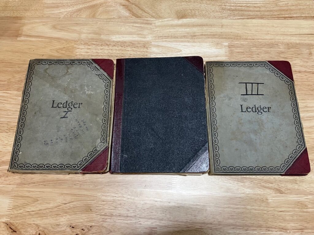 Photograph of three Ledgers numbered I, II, III, dated 1933-1942. From Box 28, Folders 2, 3, 4, IC 009 University of Texas Dental Branch records, McGovern Historical Center, Texas Medical Center Library]