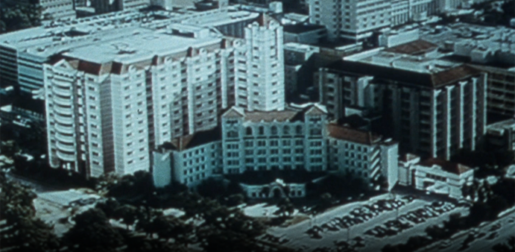 [Screenshot from Hermann Hospital "Campaign for Life": Internal Fundraising Video, aerial view showing the hospital and proposed expansion, 1980s. AVF-IC086-013, IC 086 Hermann Hospital Historical Archive records, McGovern Historical Center, Texas Medical Center Library]