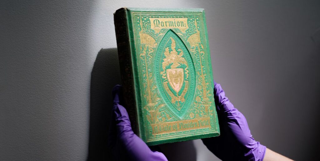 Melissa Tedone, the associate director of the Winterthur/University of Delaware Program in Art Conservation, helped launch the University's Poison Book Project, which tests the covers of antique books for toxic heavy metals. Here, she holds a copy of "Marmion."