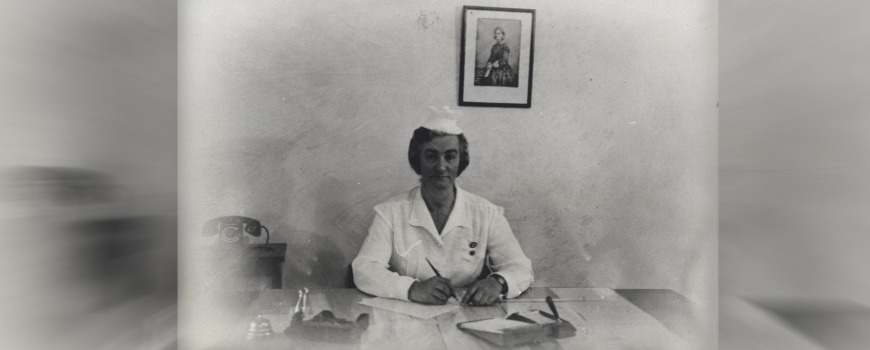 Constance White sitting at desk and writing